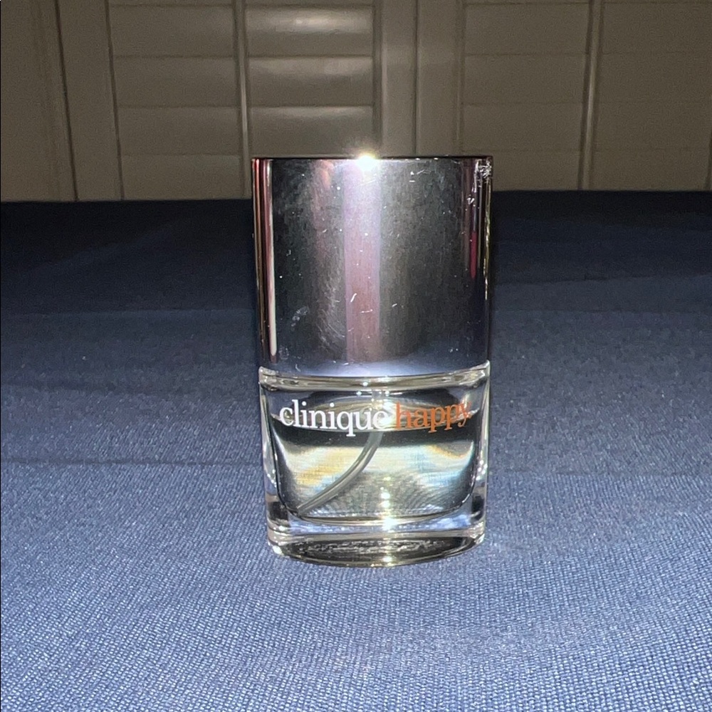 Clinique Happy Mini Bottle with Silverā Cap and Pale Yellow Liquid